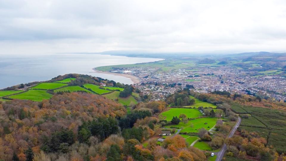 Aerial view over the site to the coast