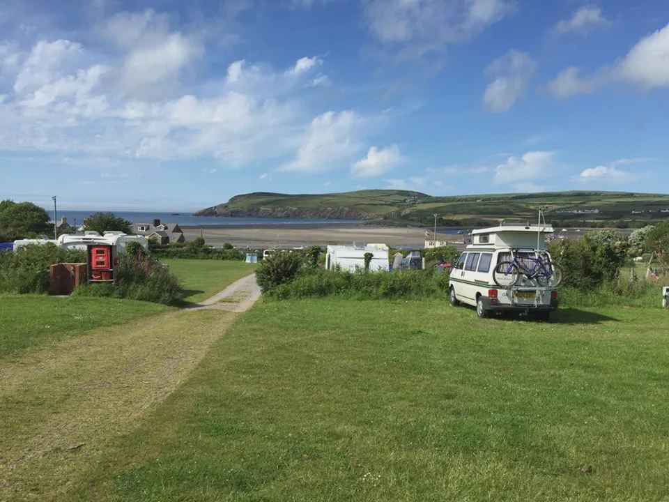 Campervan on grass with bay view