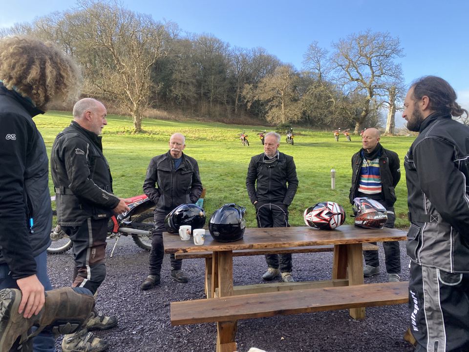 Riders by a picnic table
