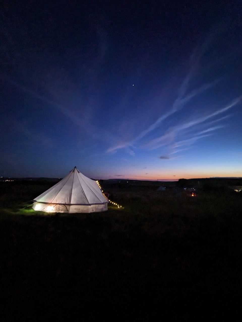 Bell tent lit at dusk