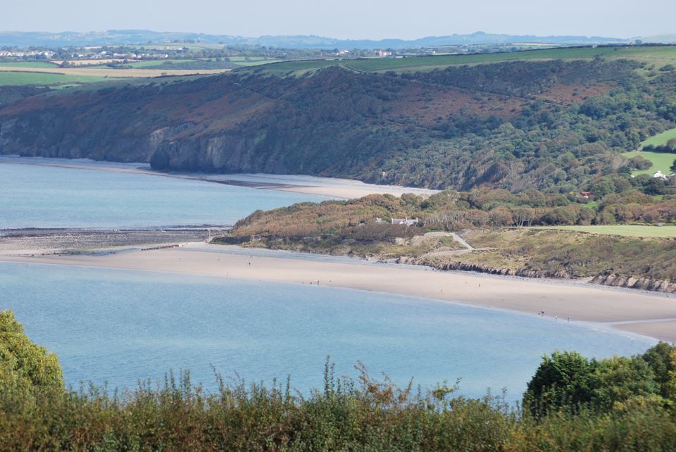 Sandy beach below the site