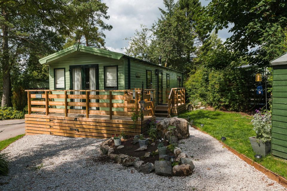 Caravan with decking and a rockery