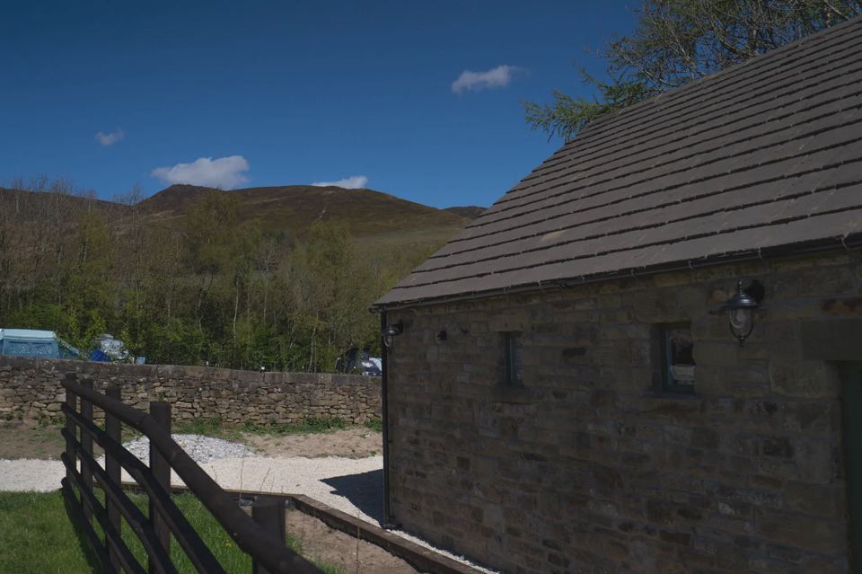 Stone barn with hills behind