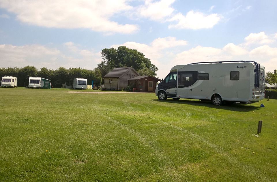 Motorhome and cabins across the field