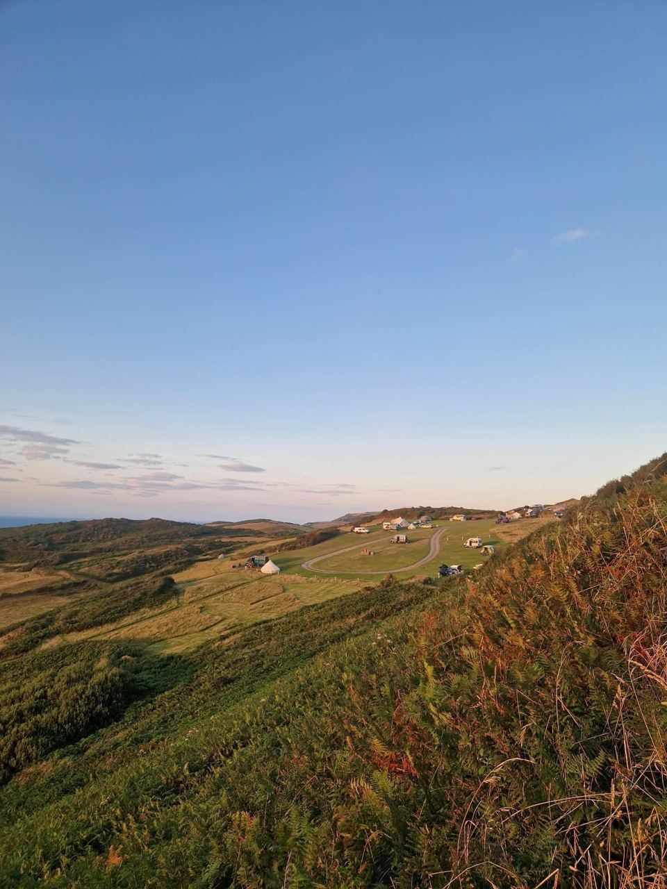 Grassy clifftop slope at dusk