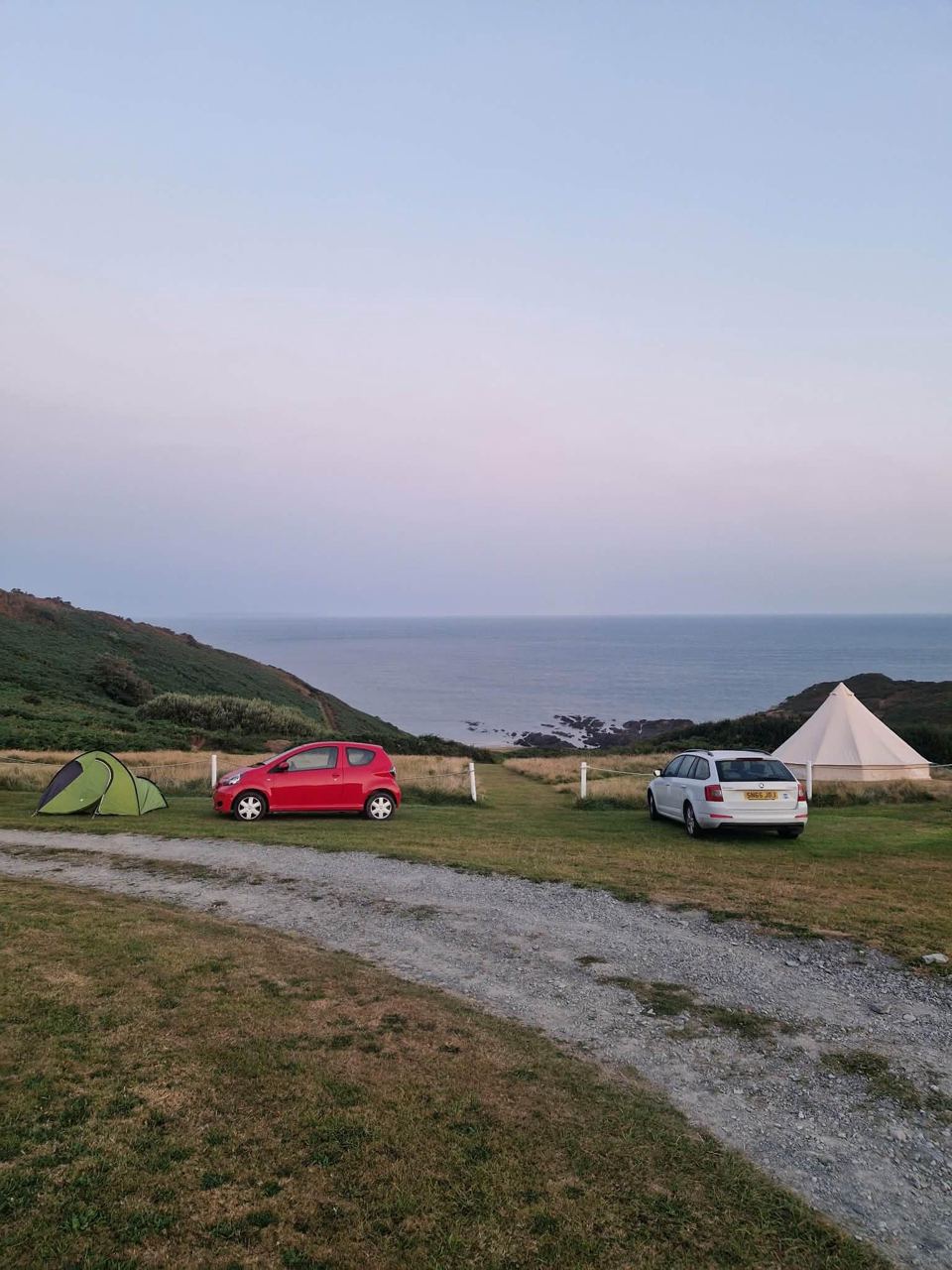 Cars and bell tent by the sea