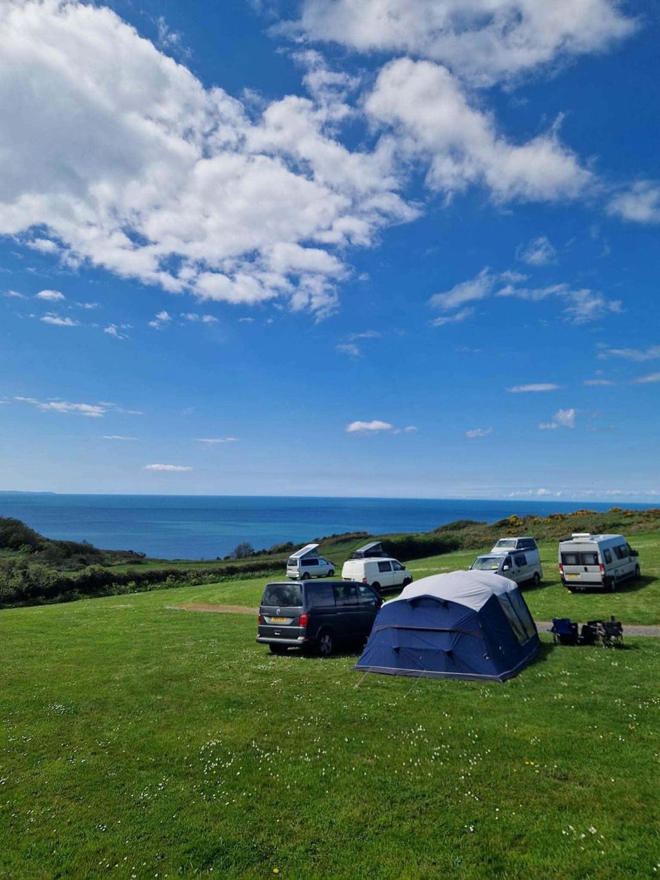 Tents on the grass with the sea beyond