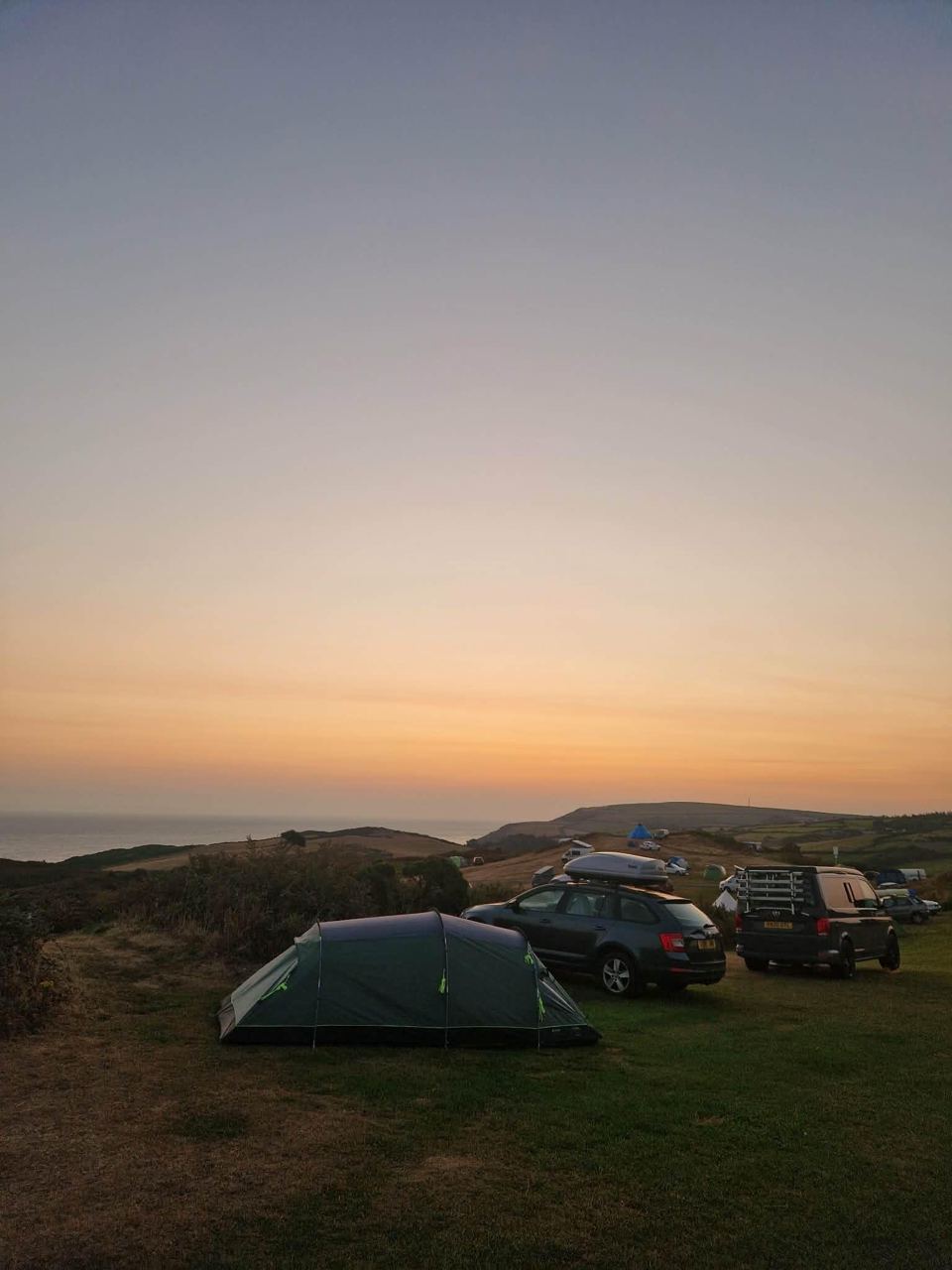 Tent and cars at dusk
