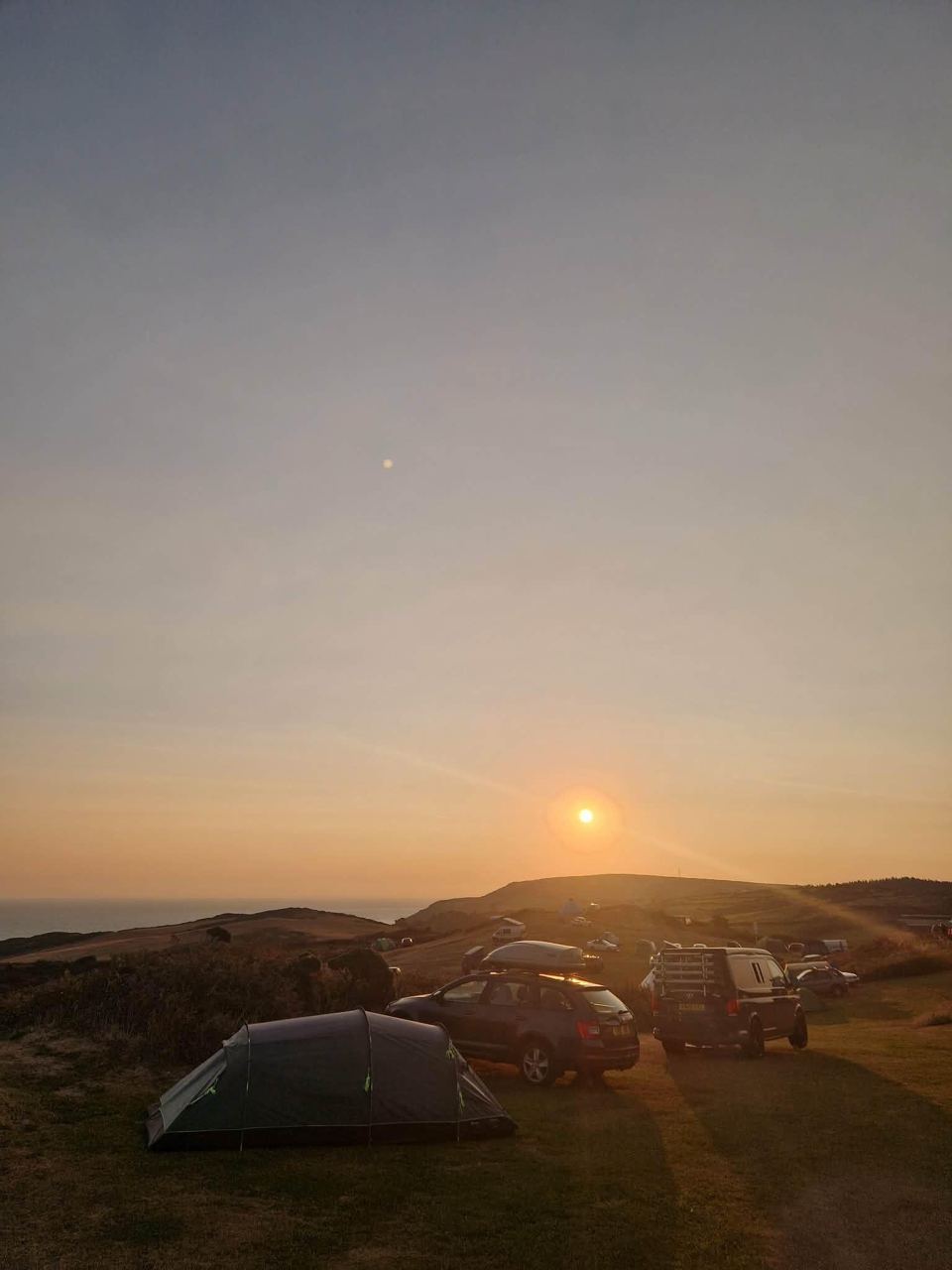 Tents and cars at sunset