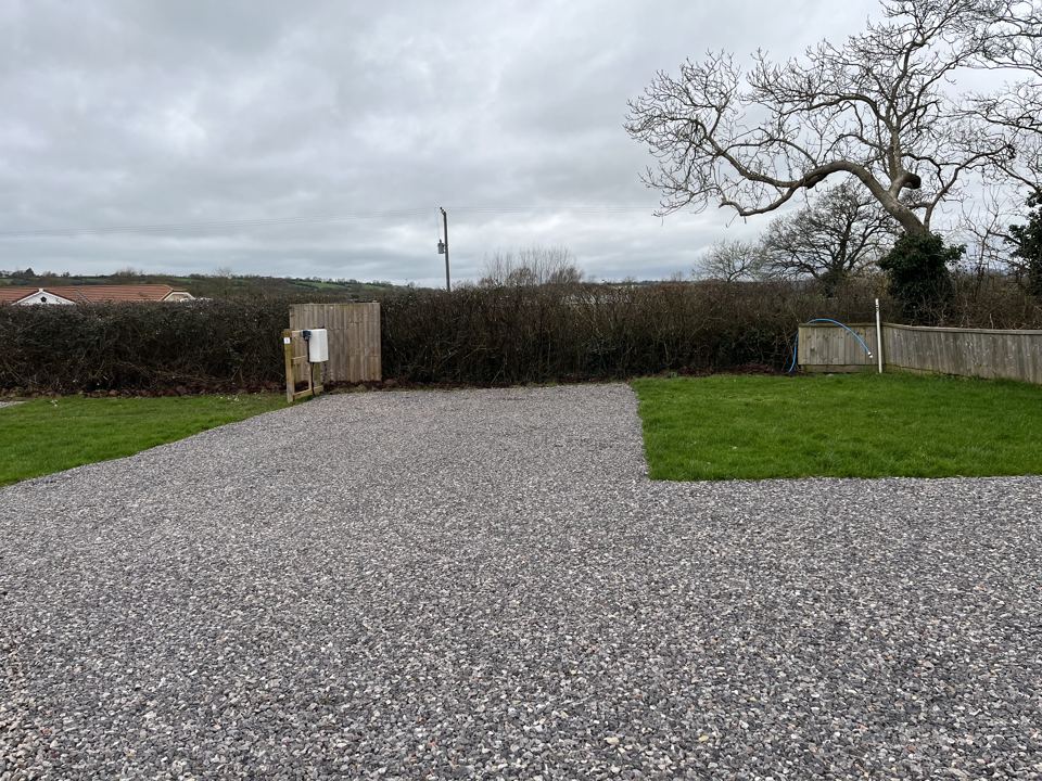 Gravel pitch with hedge