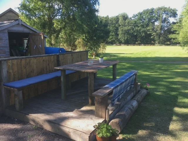 Deck and picnic table by the field