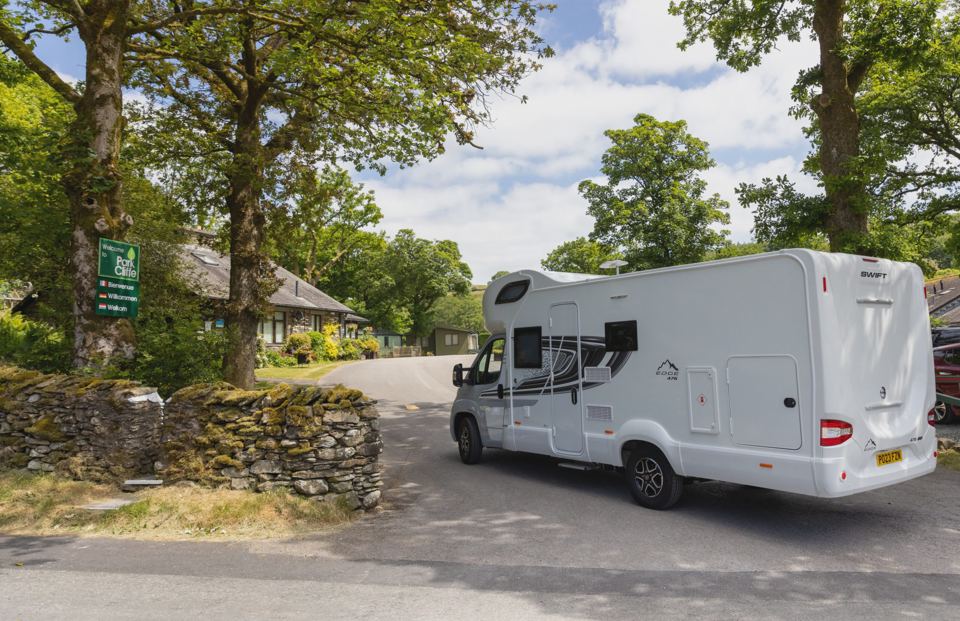 Motorhome on the drive by the trees