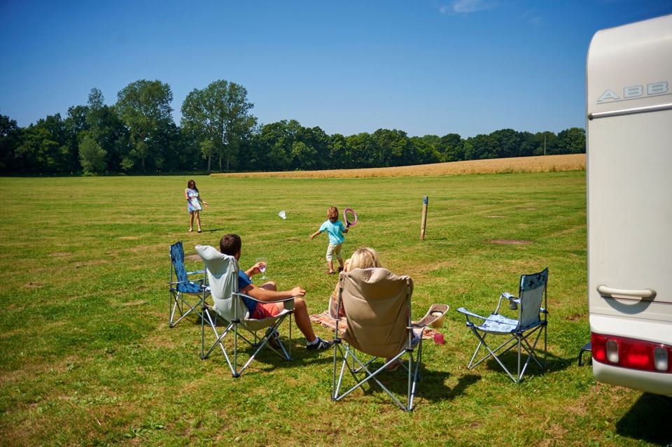 Open field beside a caravan