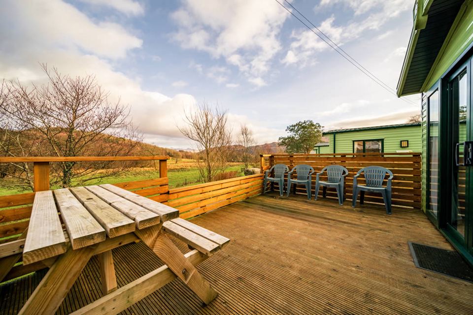 Decking beside the wooden lodge
