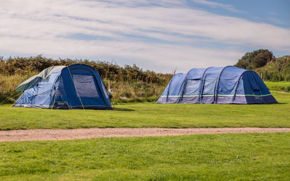 Two tents on the grass pitch