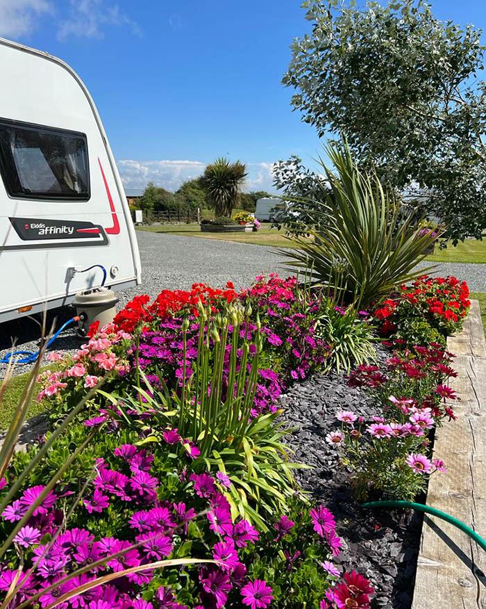 Caravan beside flower tubs