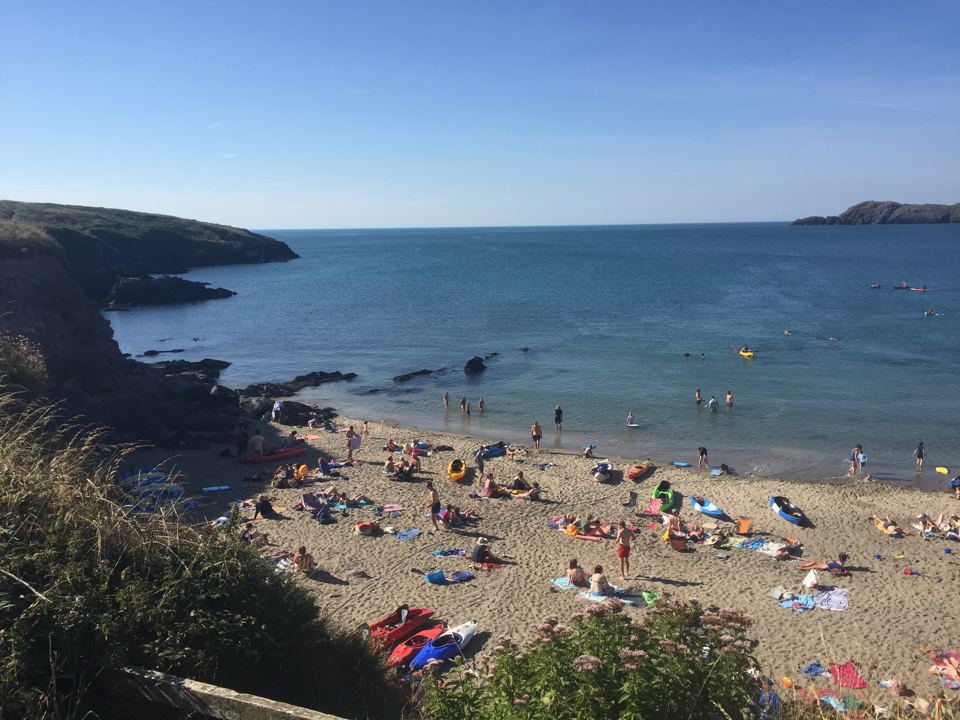 Sandy cove below the site