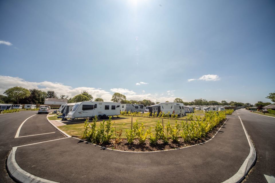 Touring pitches around a landscaped island