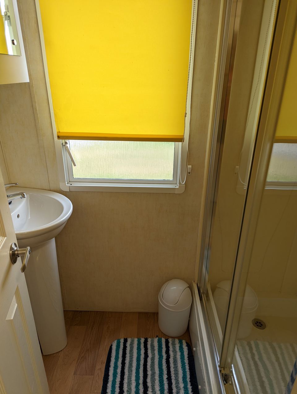 Shower room with yellow blind
