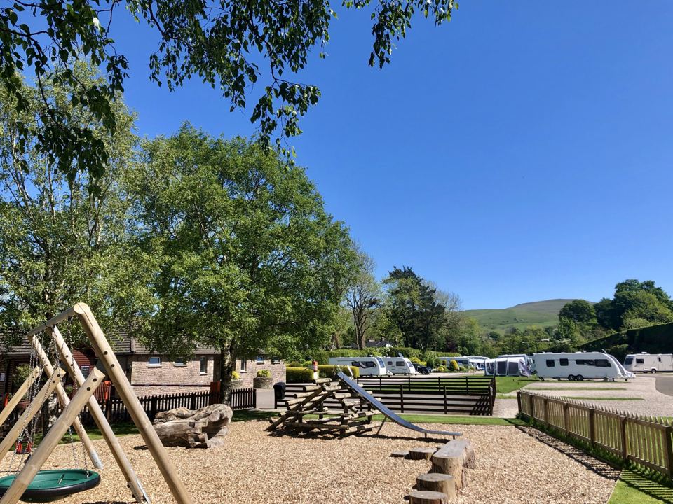 Play area with swings and slide