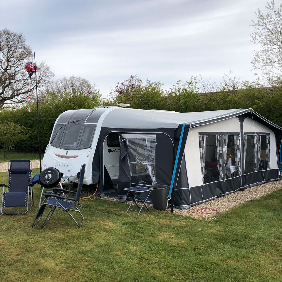 Caravan with awning on grass