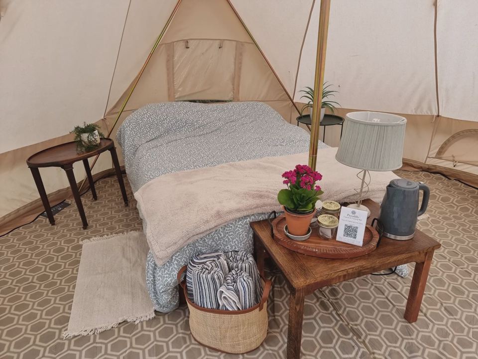 Double bed inside a bell tent