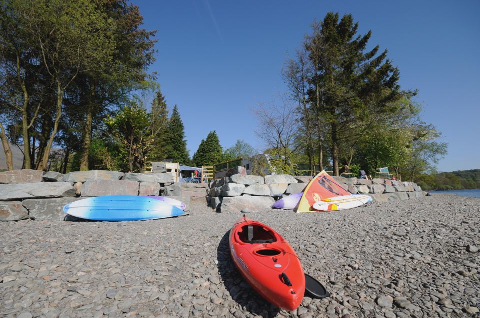 Kayak on the shore by the trees