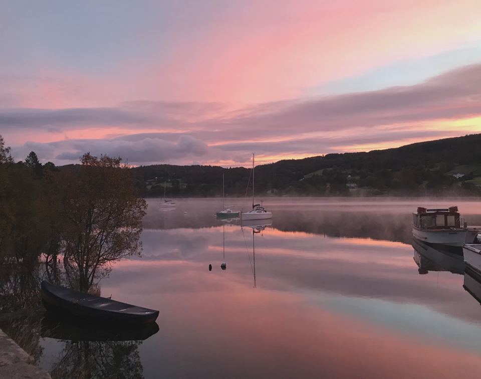 Pink sky over still lake