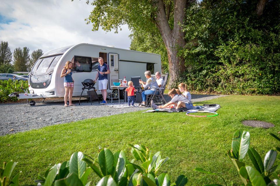 Touring caravan on grass beside the pitch