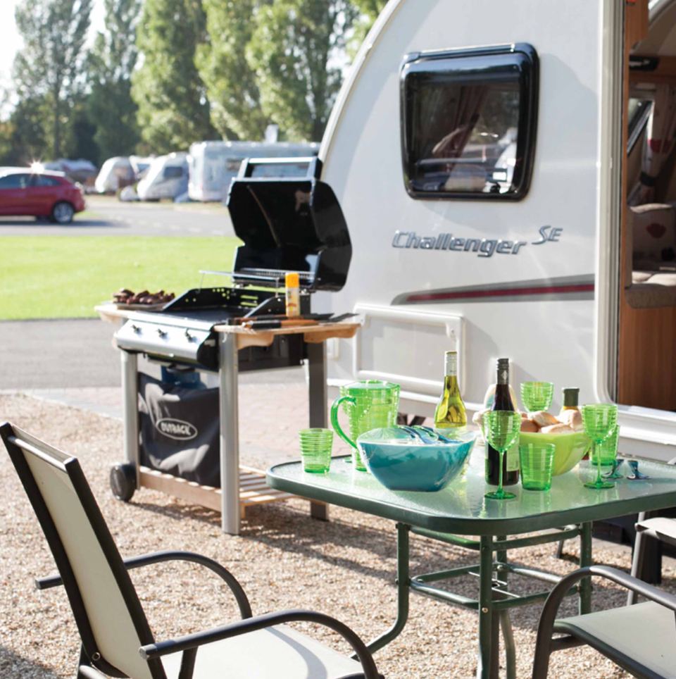 Gravel hardstanding beside a caravan