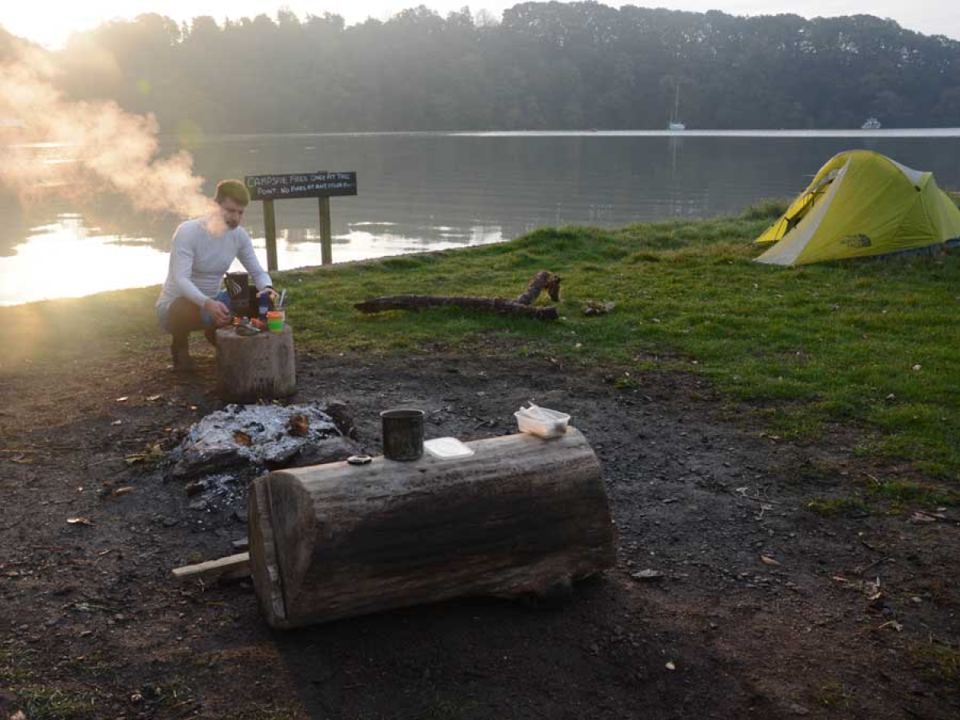 Fire pit and log bench by the river