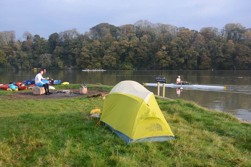 Tent on the riverbank grass