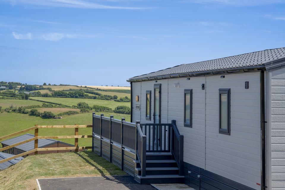 Lodge on the decking with fields beyond
