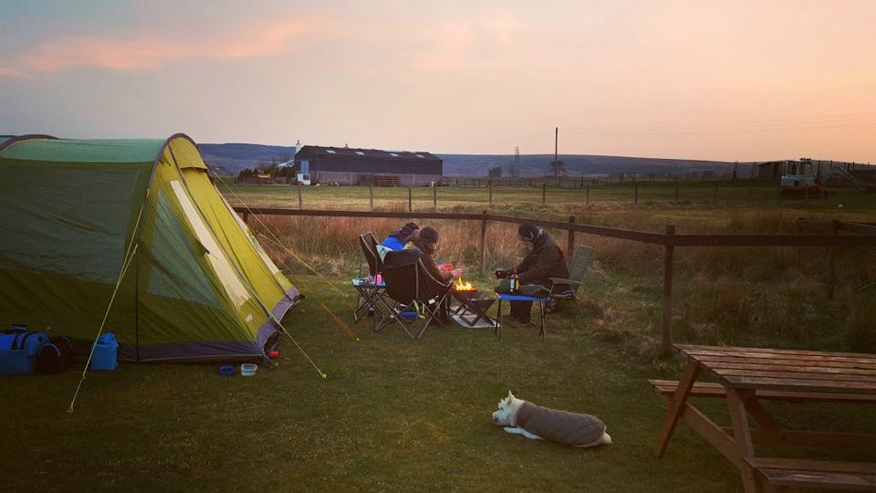 Tent and picnic bench at dusk