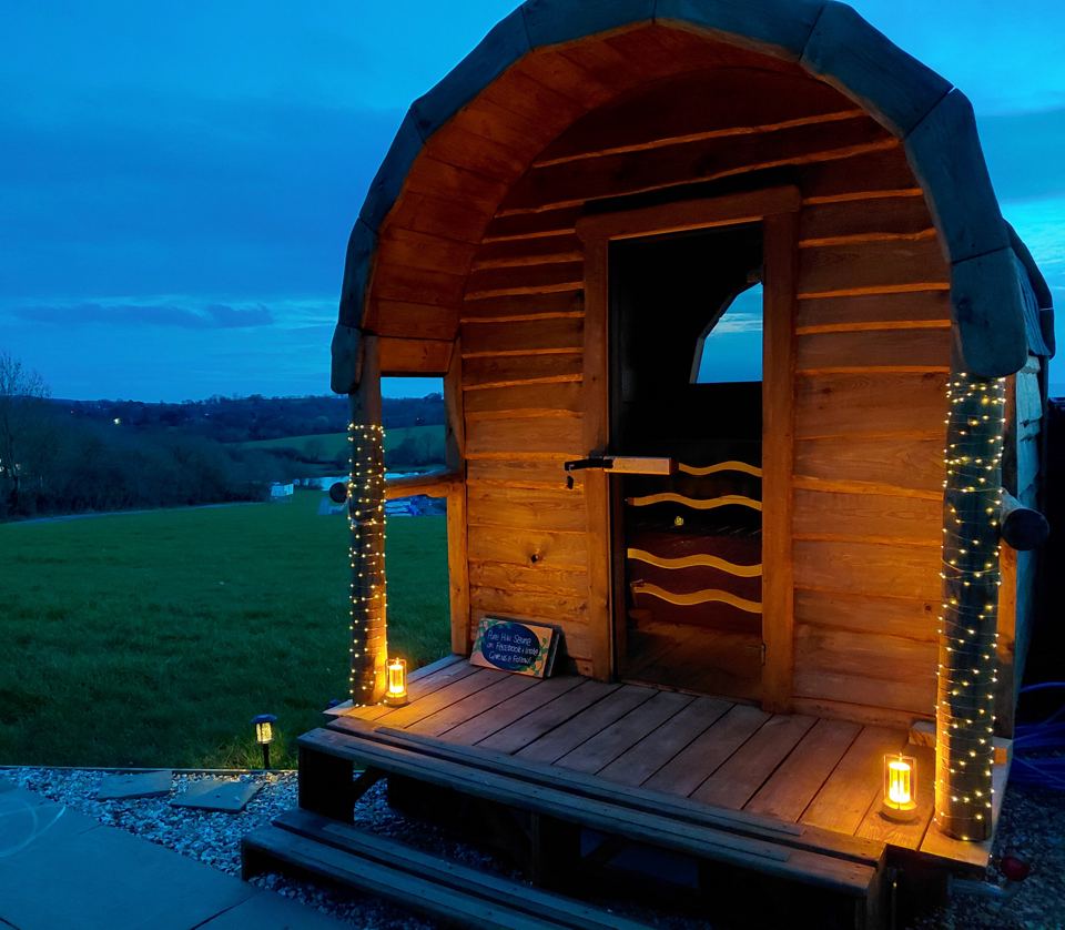 Pod lit with fairy lights at dusk