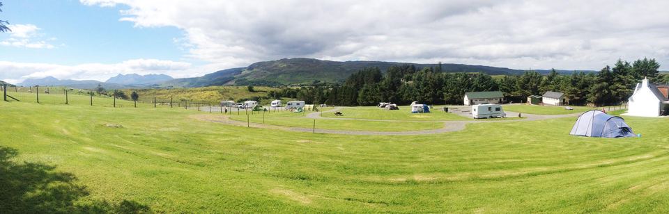 Wide grass field with Cuillin beyond