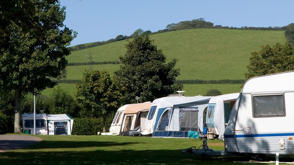 Caravans on the pitches by the hillside