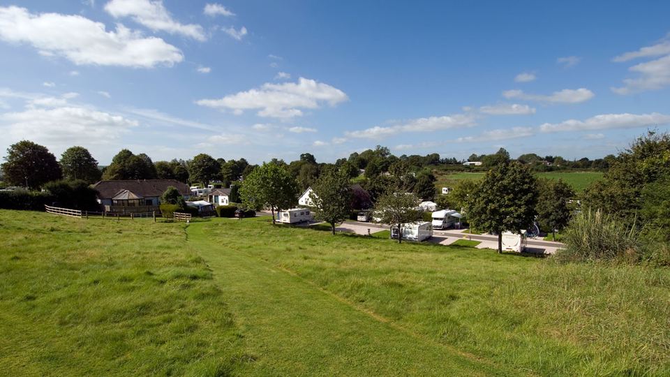 Caravans on the grass with fields beyond