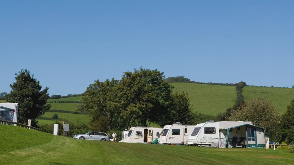 Caravans on the pitches with hills behind