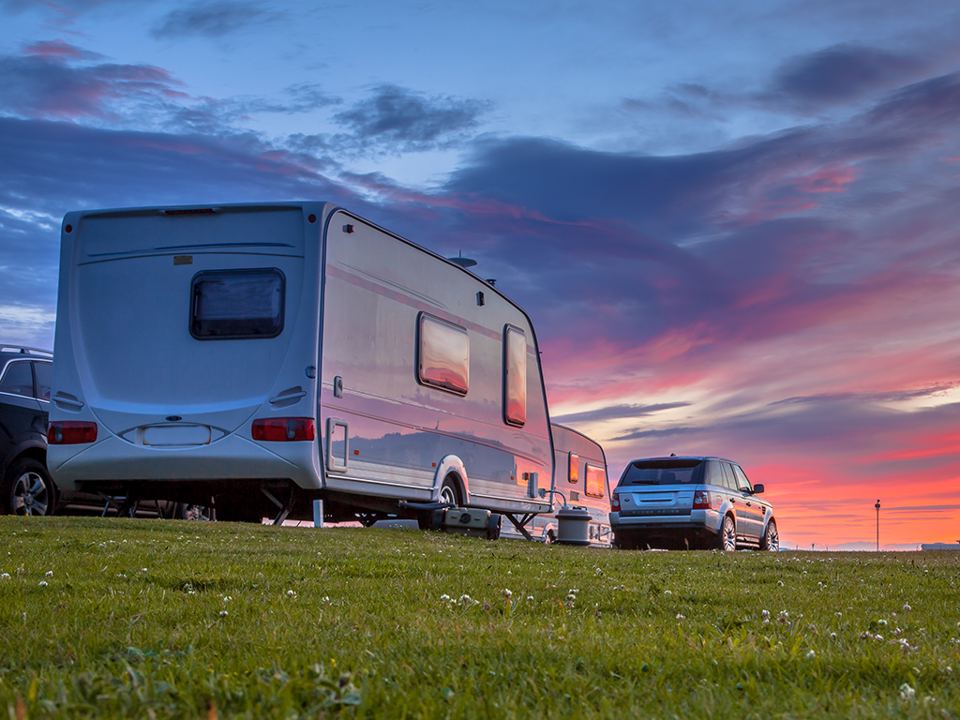 Tourer on the grass at sunset