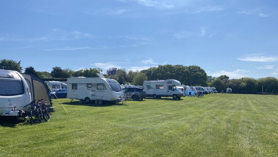 Caravans and tents on the grass field