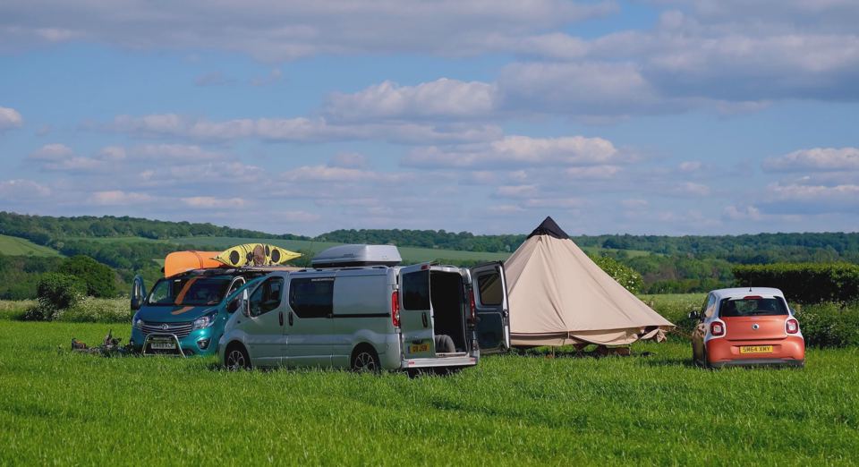 Campervans and bell tent in the field