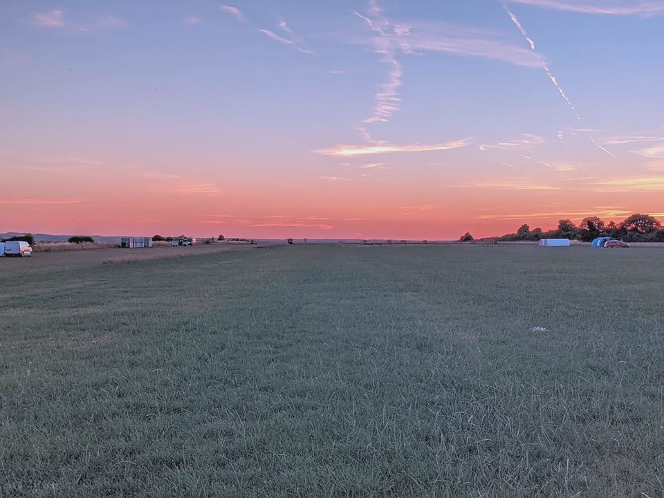 Open camping field at dusk