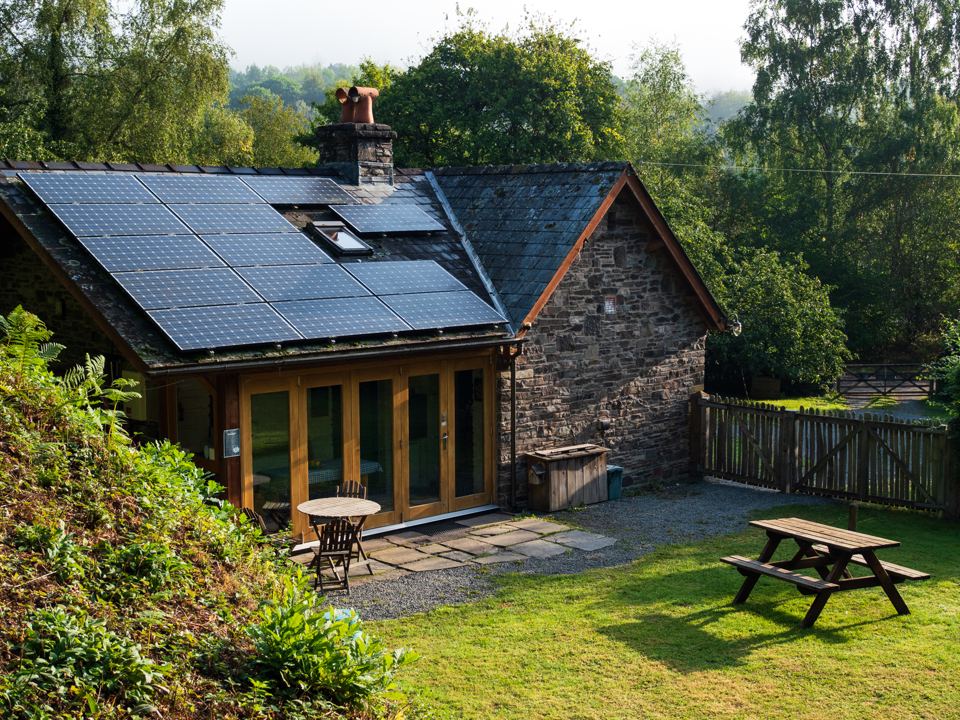 Solar-roofed stone cottage