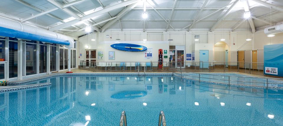 Indoor pool with a surfboard logo