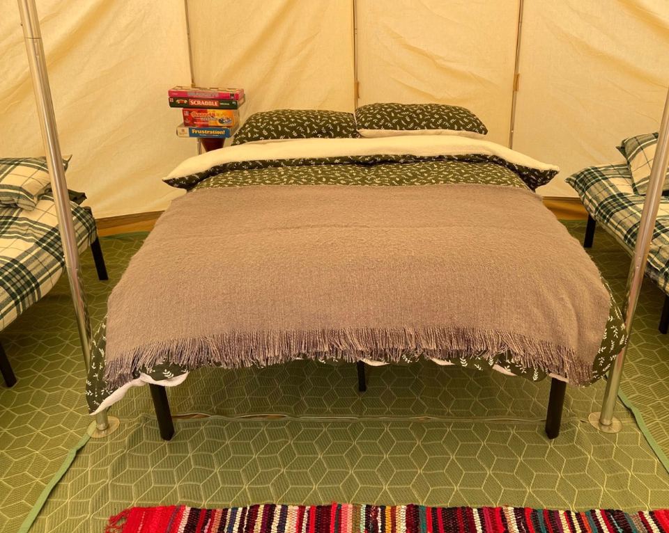 Inside a bell tent with double bed