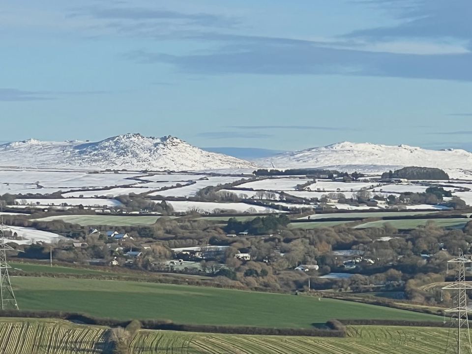 Snowy hills over the fields