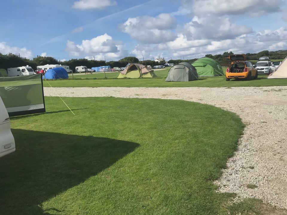 Tent pitches with campers beyond