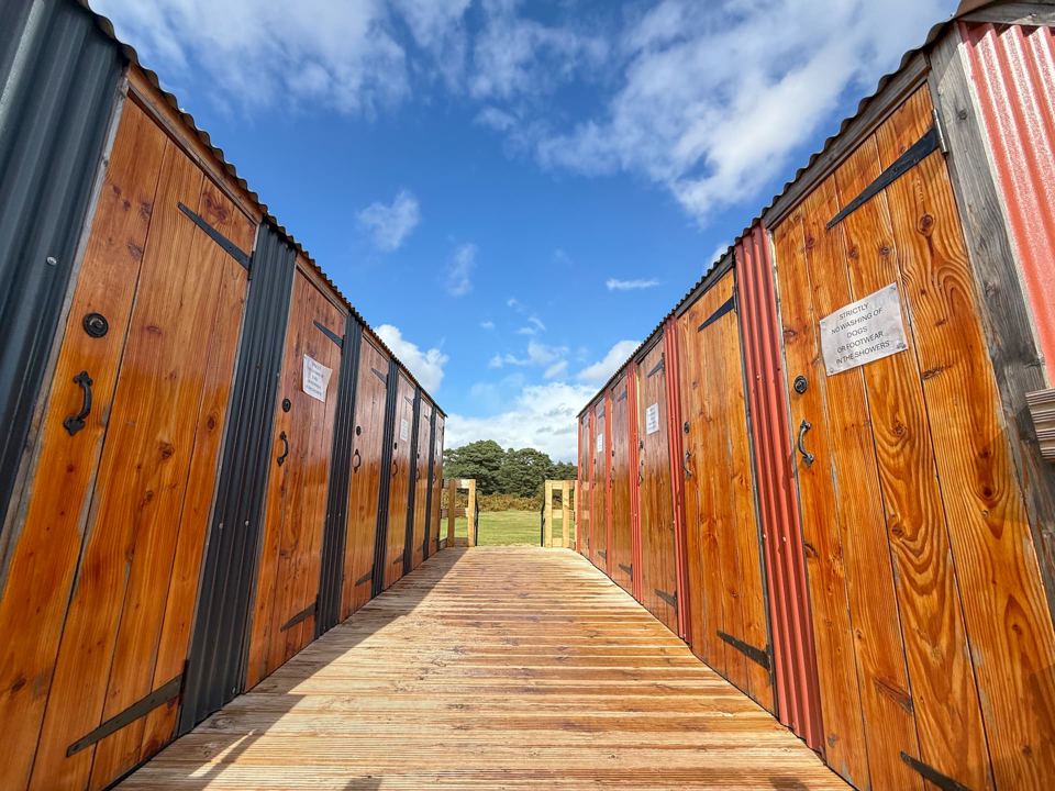 Row of timber shower cabins