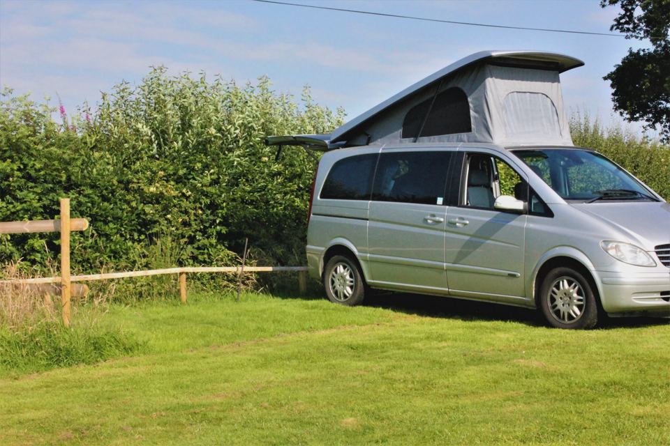 Campervan beside the hedge
